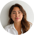 A woman with long, wavy brown hair and light skin is looking at the camera with a gentle expression. She is wearing a white collared shirt, posed against a plain white background—perfect for promoting Punta Cana tours or transfers. The image is circularly cropped.