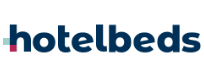 The image shows the "hotelbeds" logo in lowercase dark blue letters. To the left, a small cyan square sits above a pink one, separated by white. The background is white—perfect for companies offering best transfers and tours en Punta Cana.